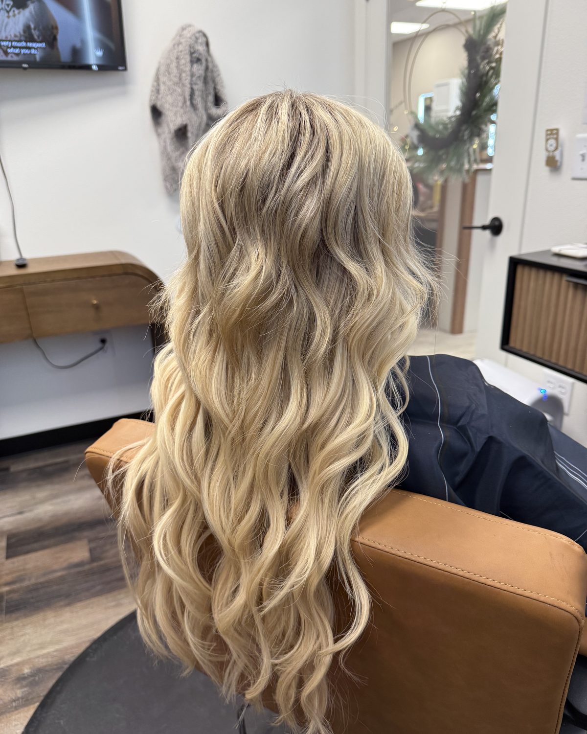 After: full, long, dimensional blonde hair following an Invisible Bead Extensions install at Emerald Salon & Suites